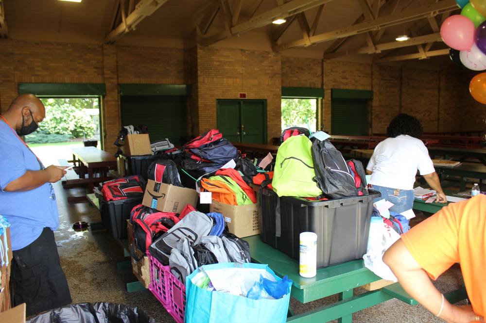 Volunteers Organizing Backpacks Indoors